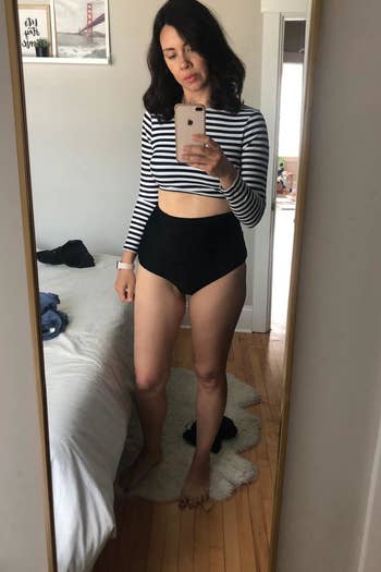 a reviewer in the black and white strip swim suit