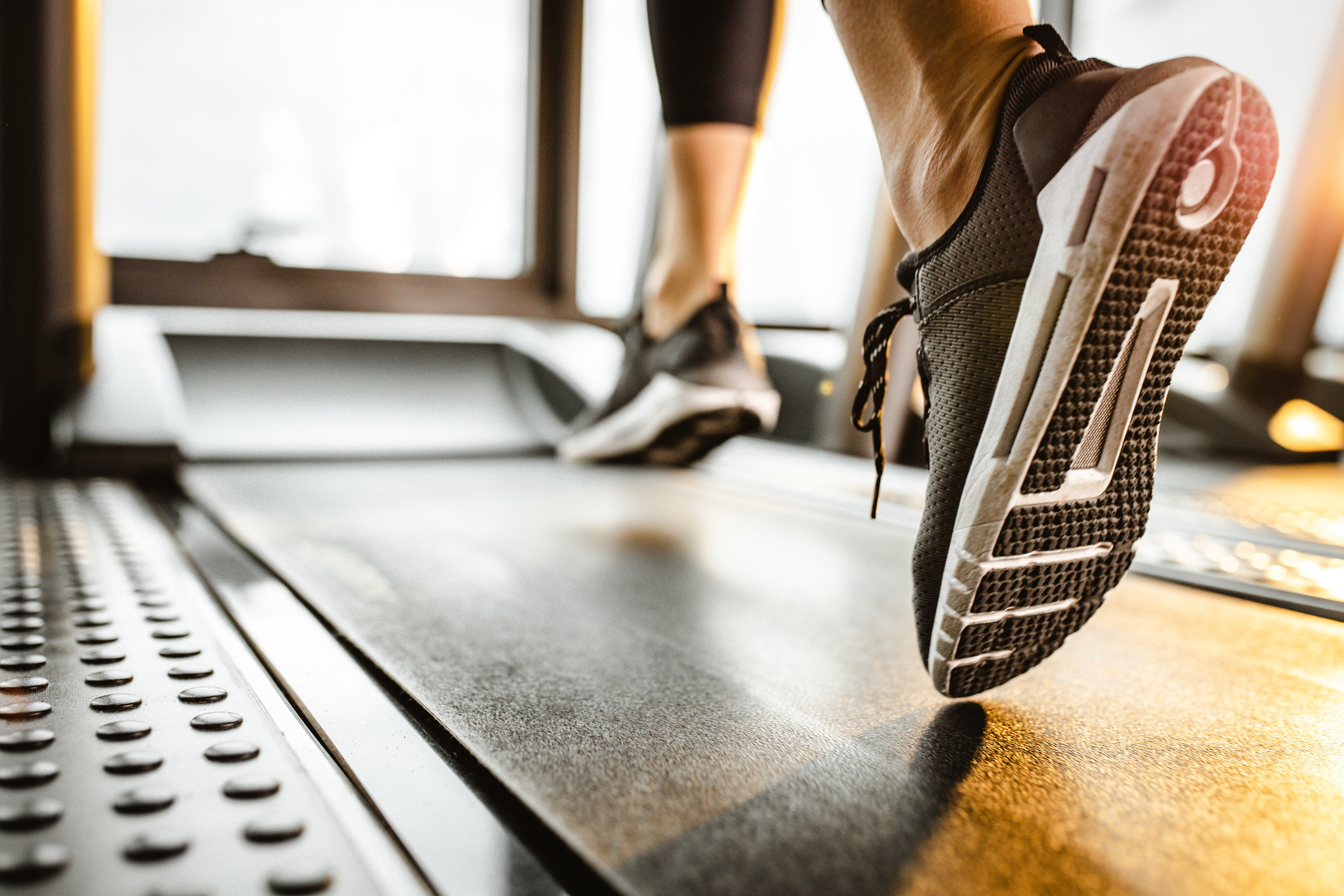 Sneakered feet on a treadmill