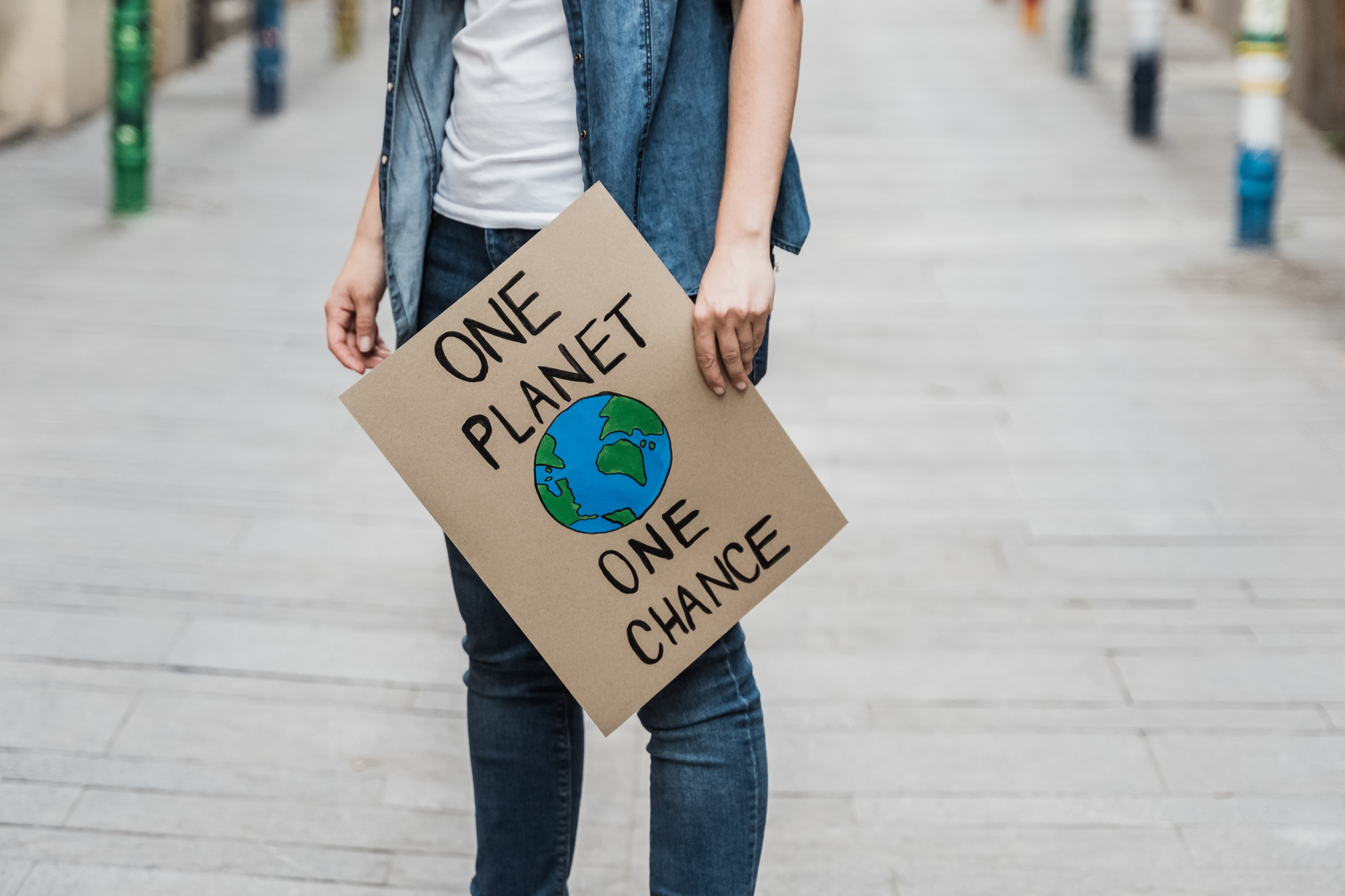 person holding a sign about climate change