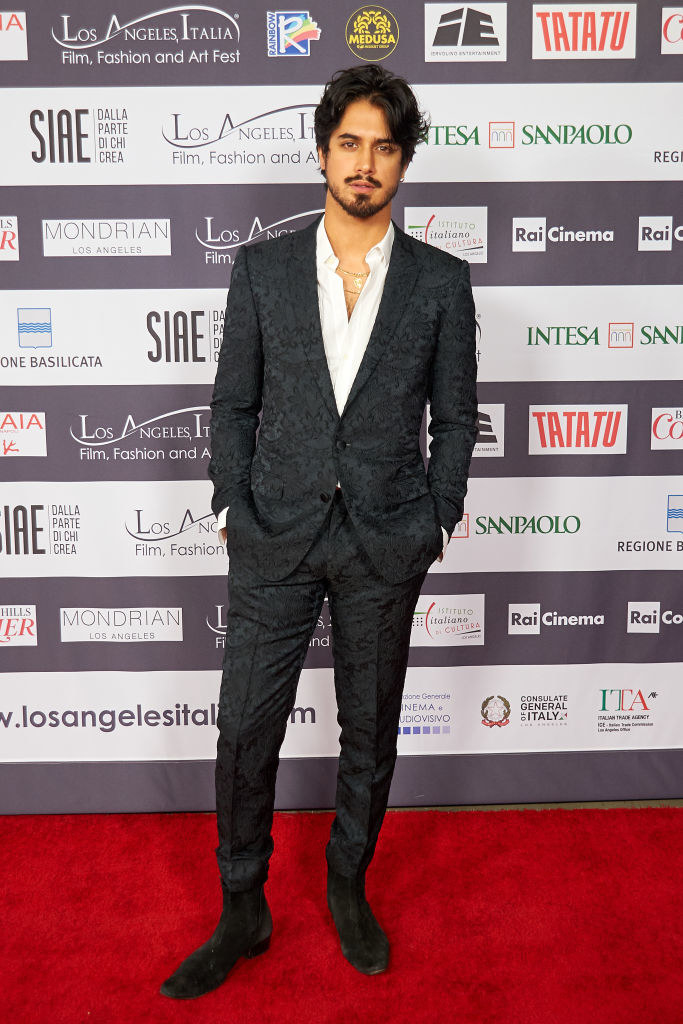 Avan in a suit, no tie, and a goatee and mustache