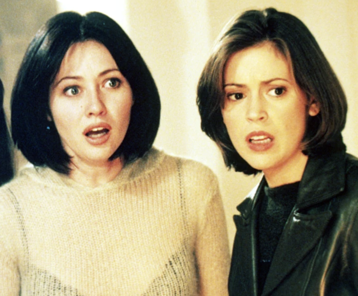 Shannen Doherty and Alyssa Milano looking shocked in a still from Charmed