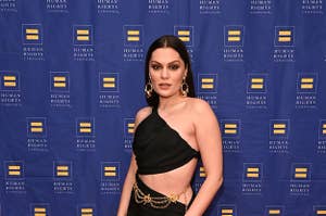 Jessie J poses on the red carpet while wearing a dress