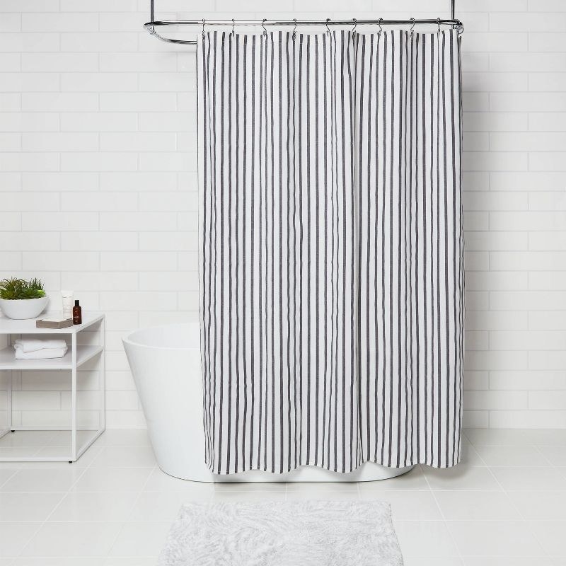 The black and white striped shower curtain in a bathroom
