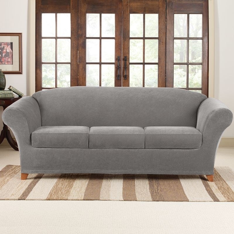 The couch in a gray slipcover