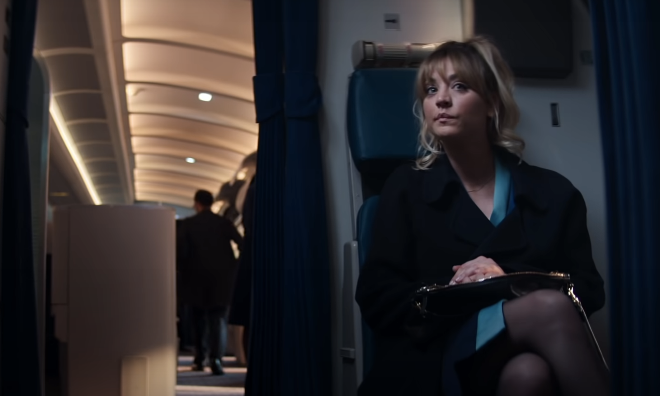 Kaley Cuoco sitting in her seat on a plane in &quot;The Fight Attendant&quot;