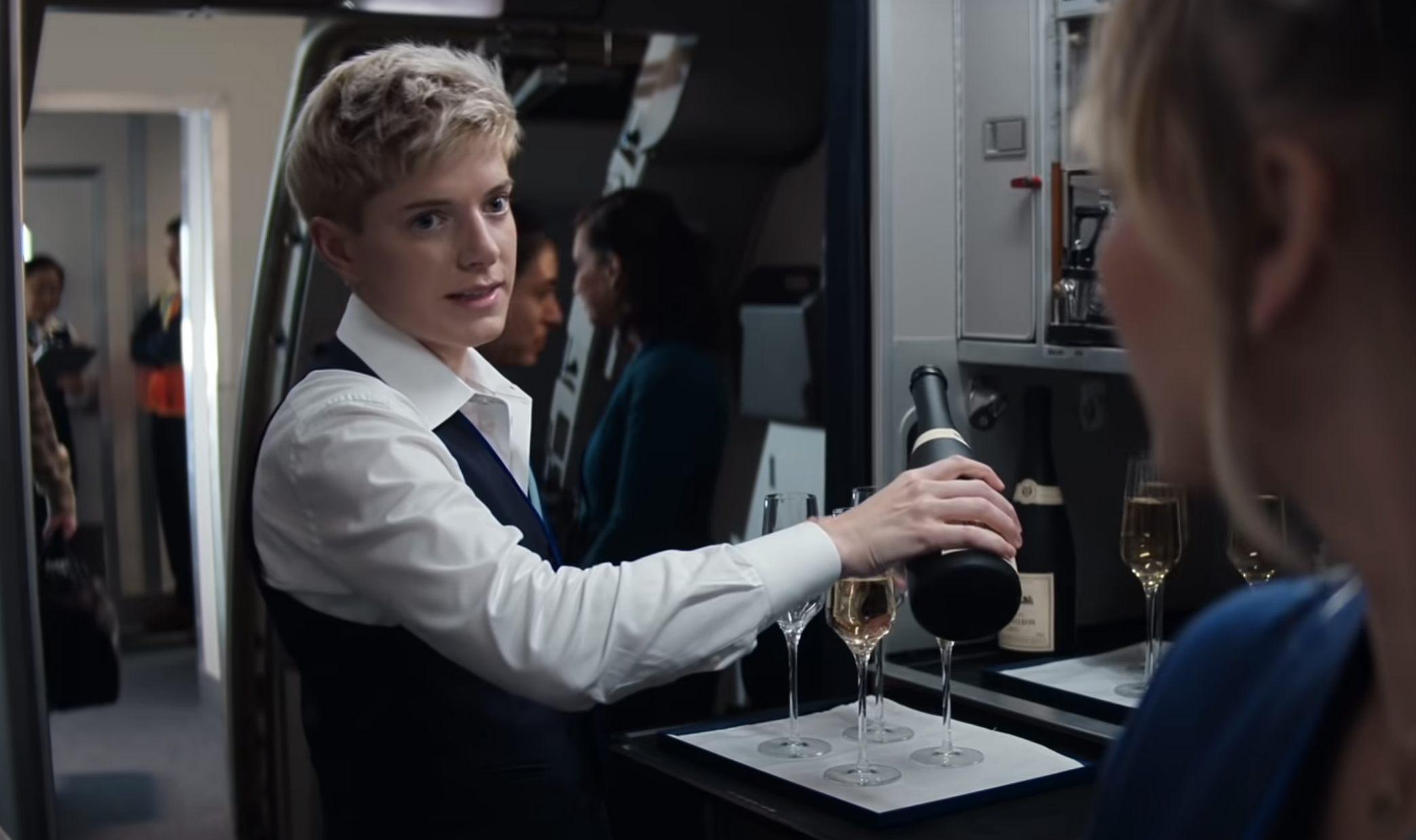 Mae Martin pouring drinks on the plane in &quot;The Flight Attendant&quot;
