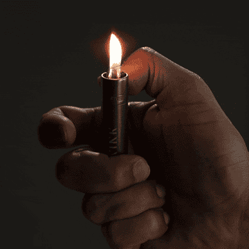 close up of a hand holding a lighter