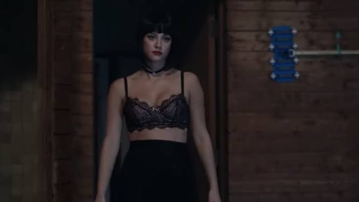 Dark Betty in a black wig, lace bra and skirt