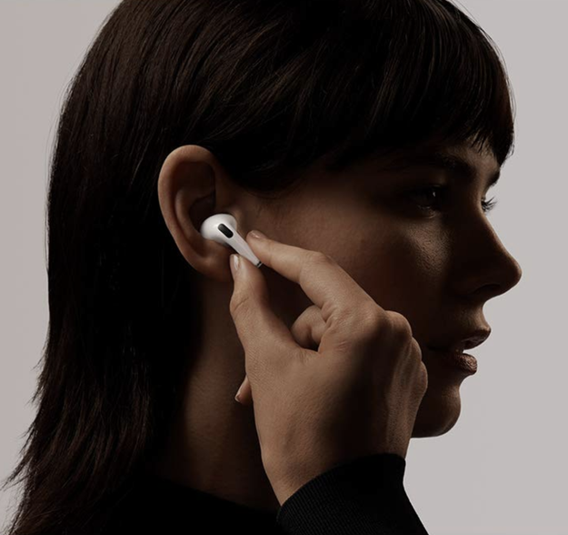 Model putting white AIrPods Pro earbud into ear