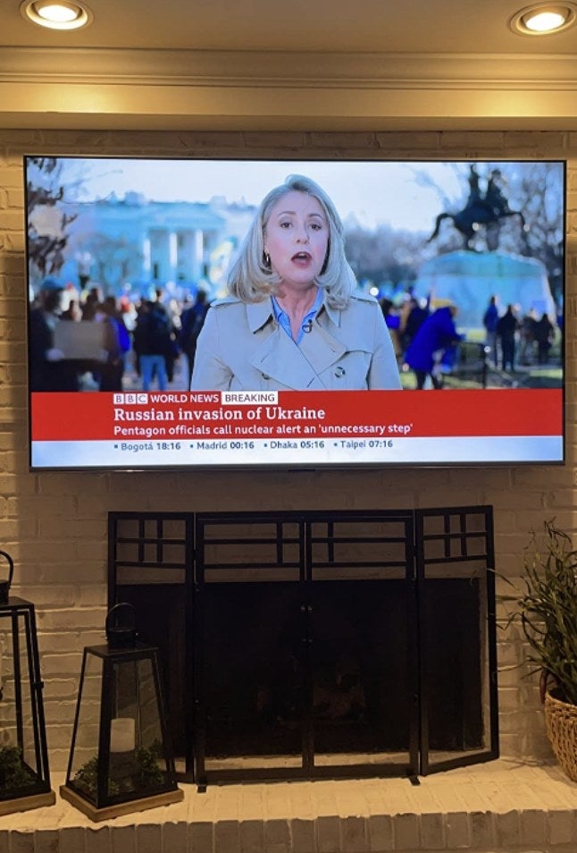 reviewer&#x27;s photo of the tv mounted about fireplace with clear display of news