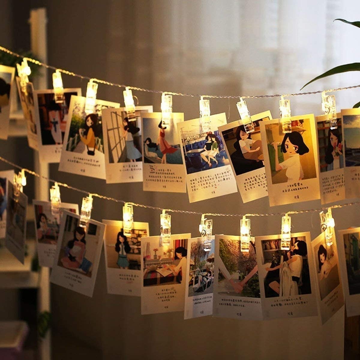 Rows of polaroid photos hung up against fairy lights