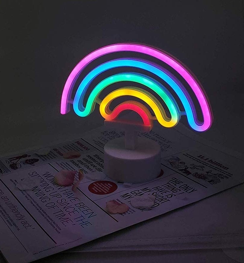 A rainbow neon light on top of a magazine