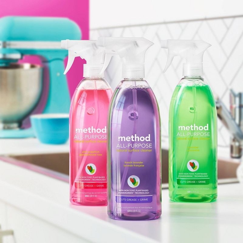 a green, purple, and pink bottle of cleaner