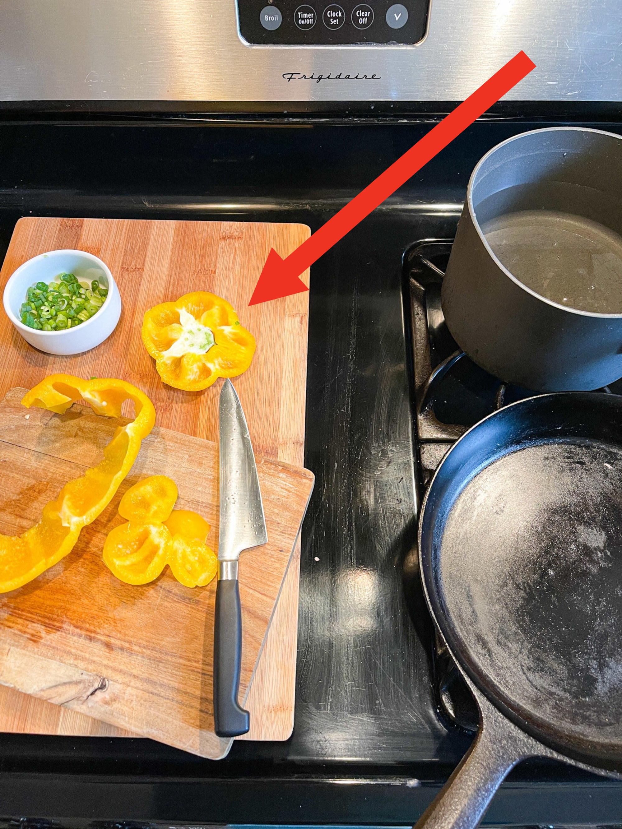 arrow pointing to bamboo burner cover over stove top