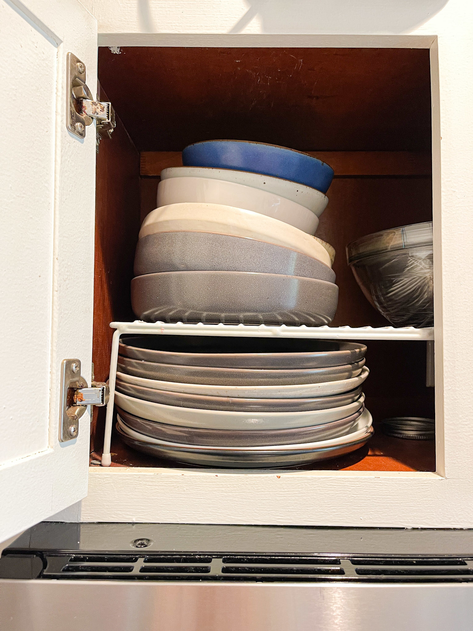 bowls and plates stacked in a cabinet
