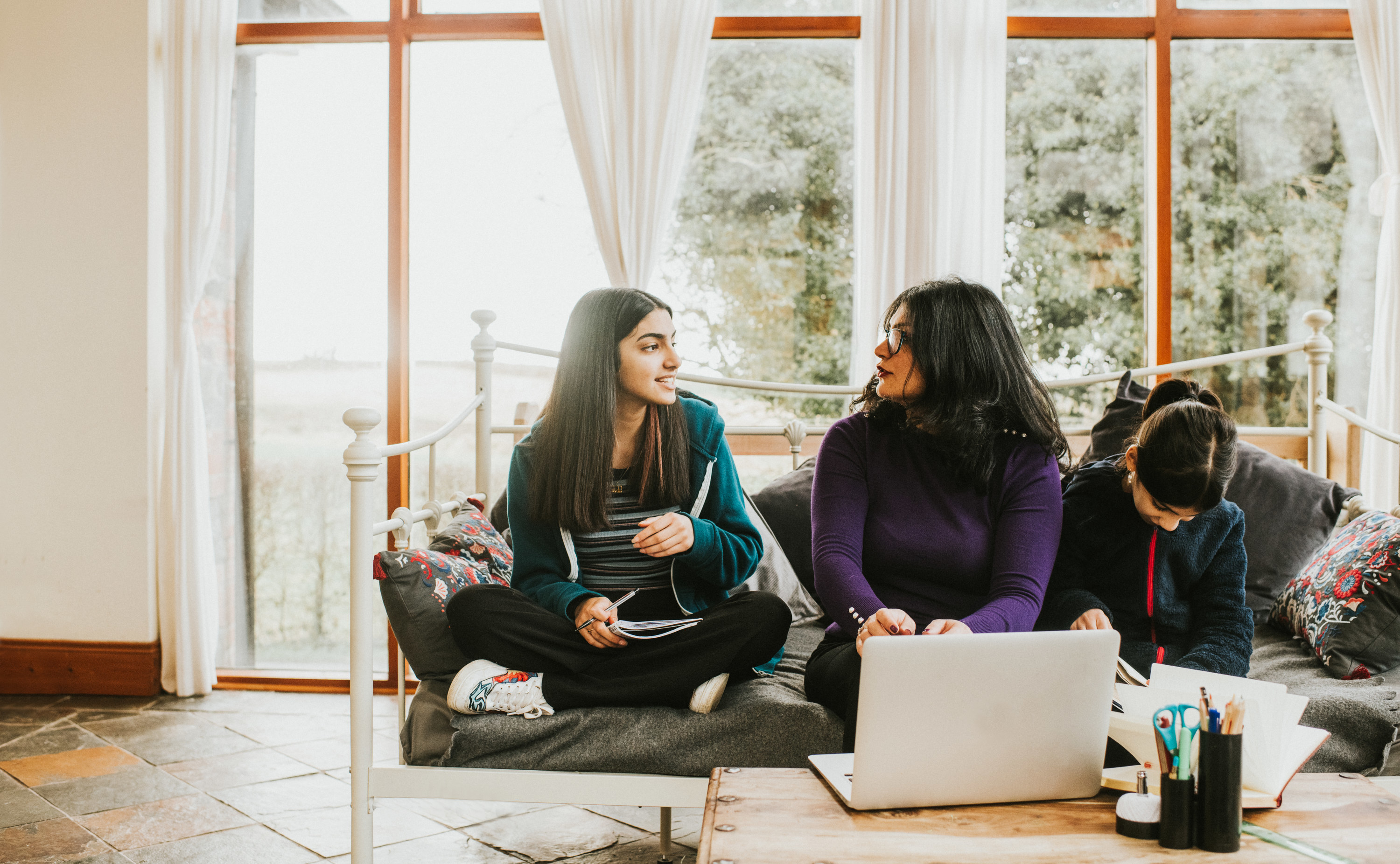 Mom sitting with her teenage daughters