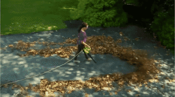 a gif of a person using the leaf blower