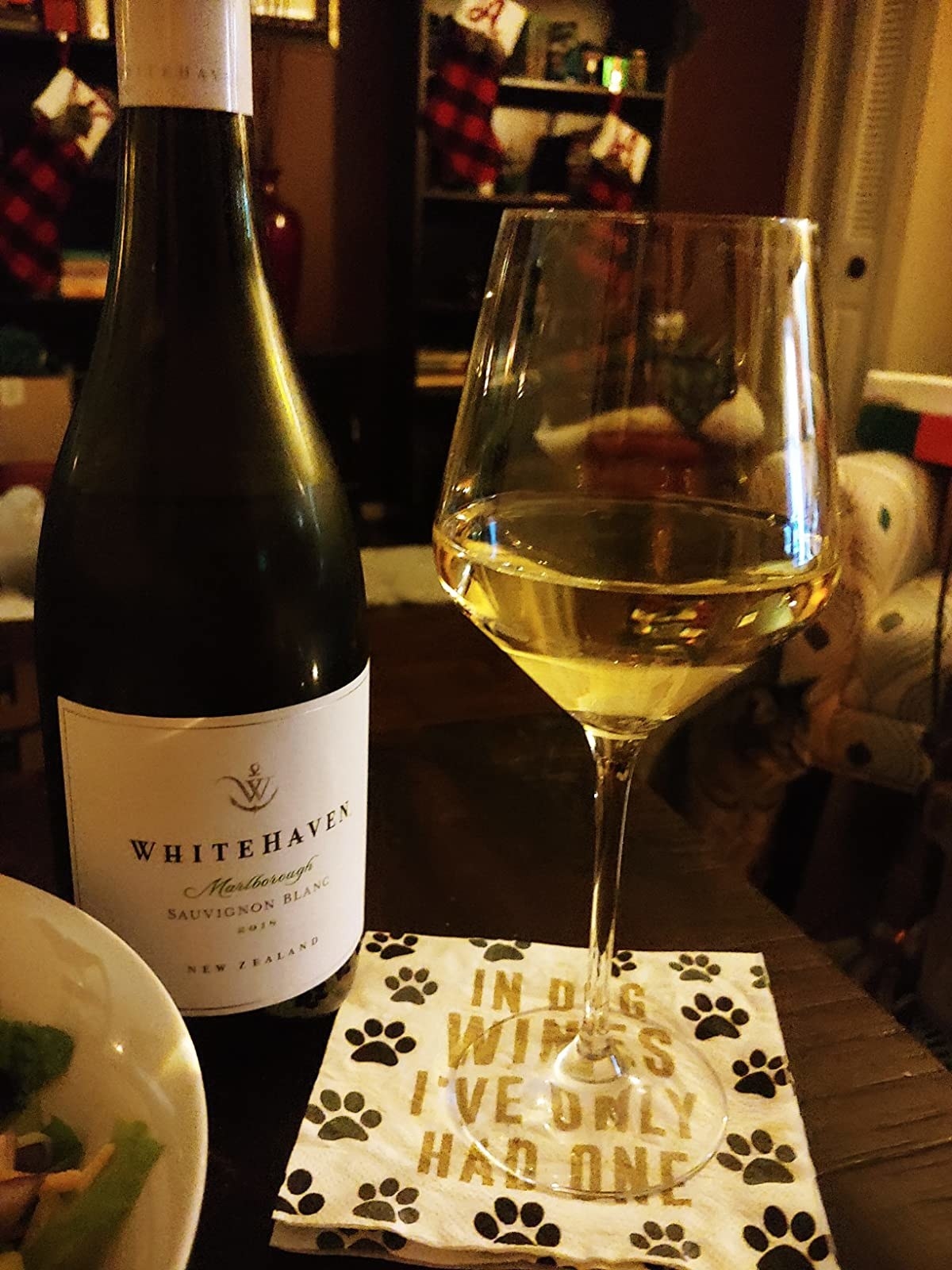 Reviewer's photo of a single wine glass filled with white wine sitting next to the bottle