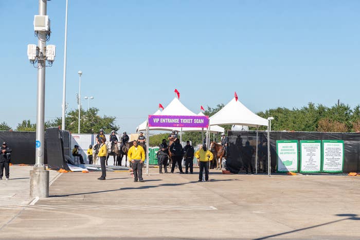 Security people and guards outside the gate labeled "VIP Entrance Ticket Scan"