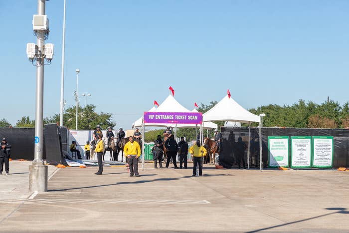 Security people and guards outside the gate labeled &quot;VIP Entrance Ticket Scan&quot;