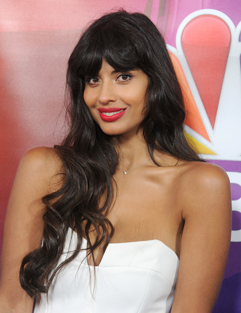 Smiling Jameela wearing a strapless outfit