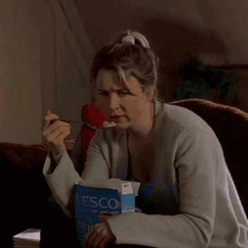 Bridget Jones eating milk and cereal out from the box