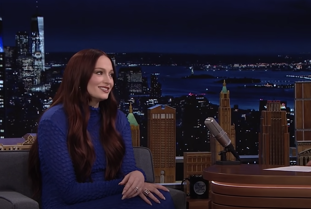 Sophie smiling on the couch of the talk show