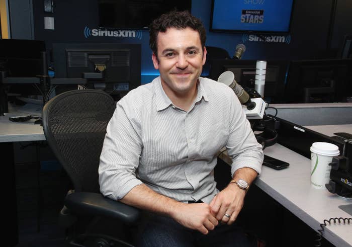 Fred sitting at a desk and smiling