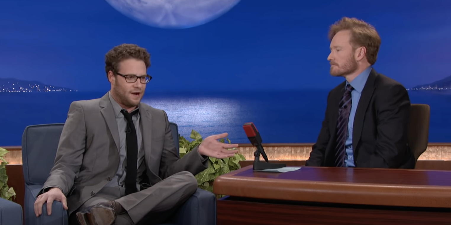 Seth sitting with Conan O&#x27;Brien on the late show
