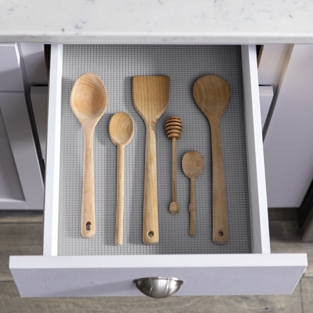 Gray liner in drawer with wooden spoons