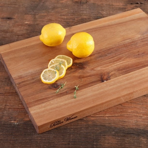 Wood cutting board with lemons on it