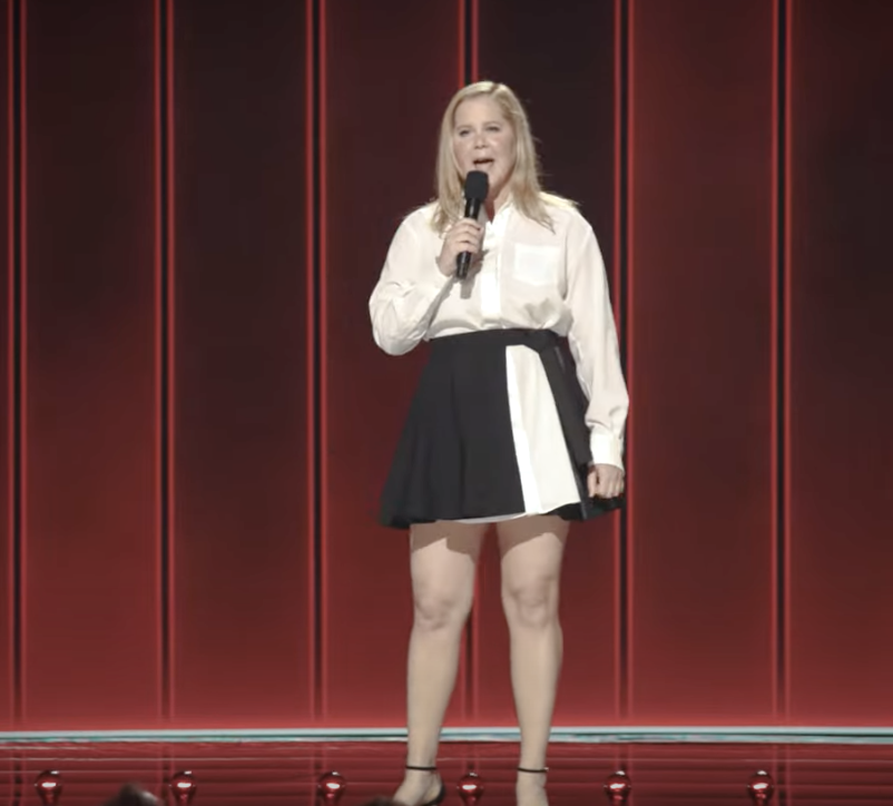 Amy Schumer performing onstage.