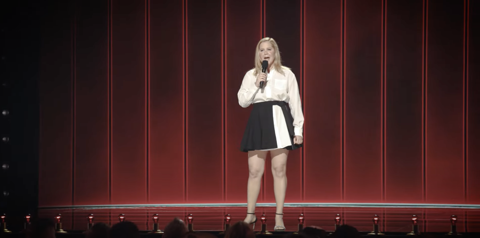 Amy Schumer performing onstage.