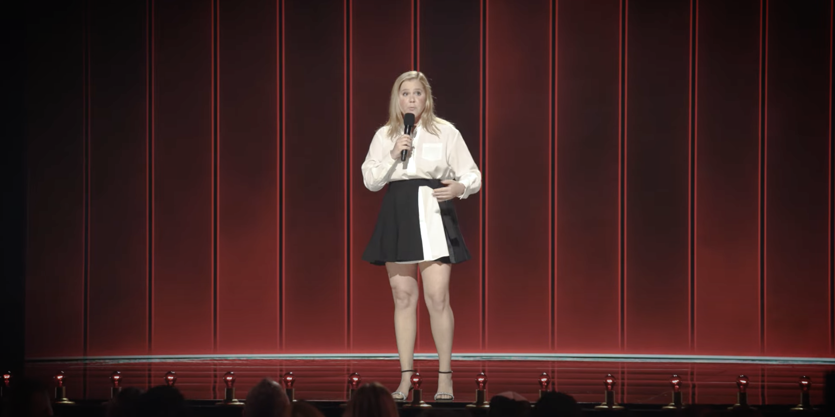 Amy Schumer performing onstage.