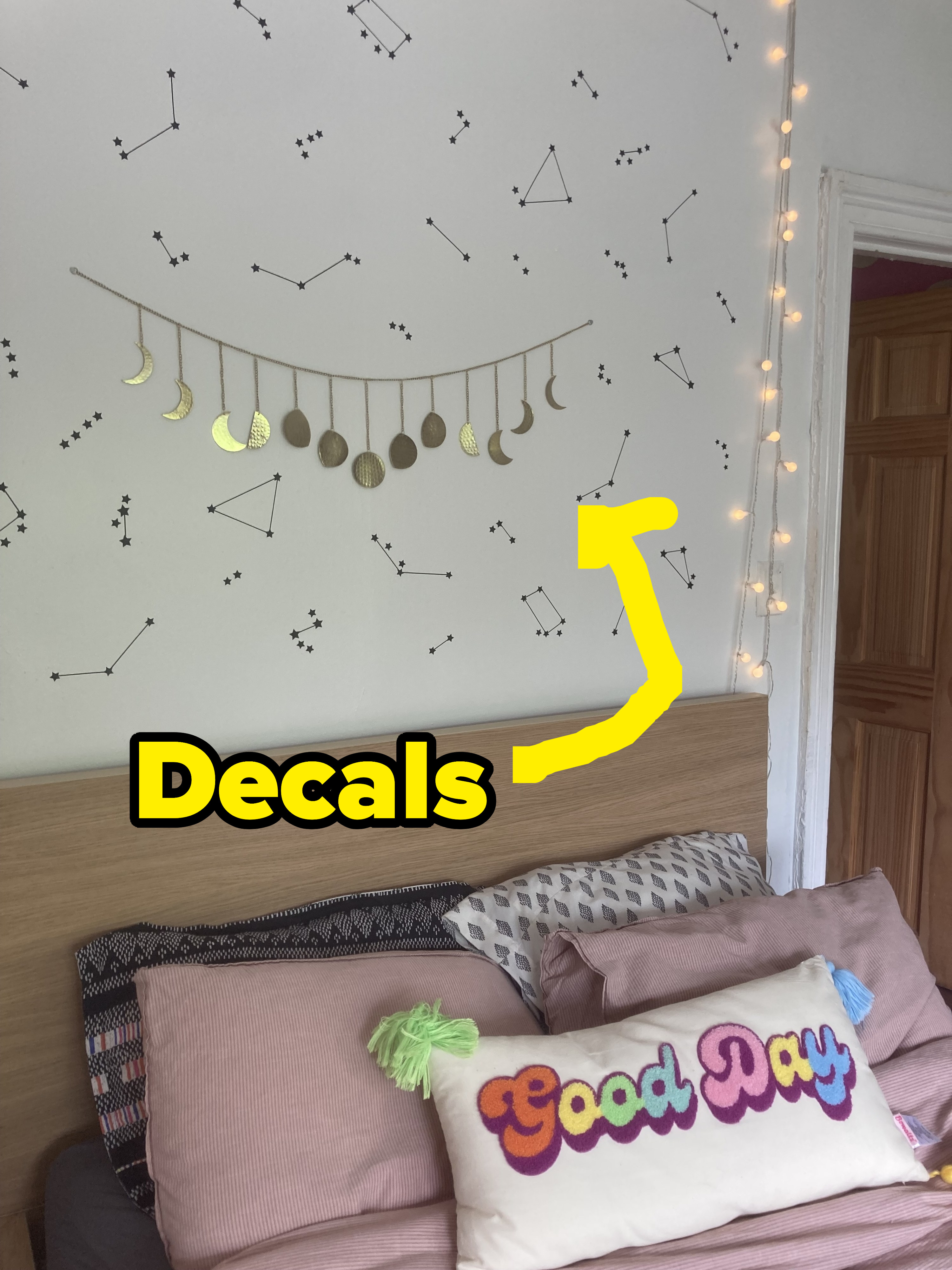 Wall decals over a bed.