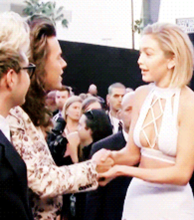 Gigi Hadid shaking Harry Styles&#x27; hand.