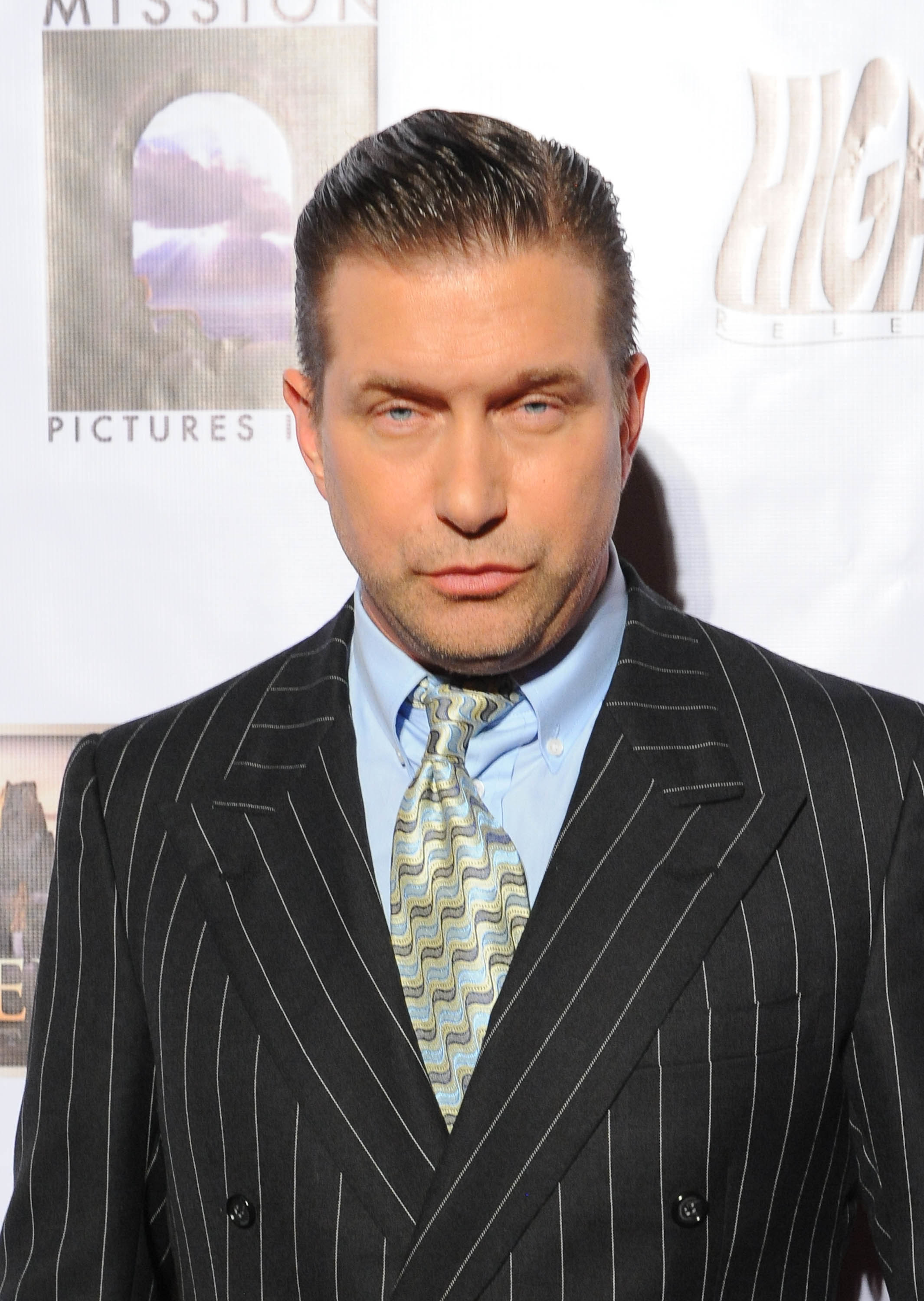 Stephen Baldwin staring down the camera in a pinstripe suit