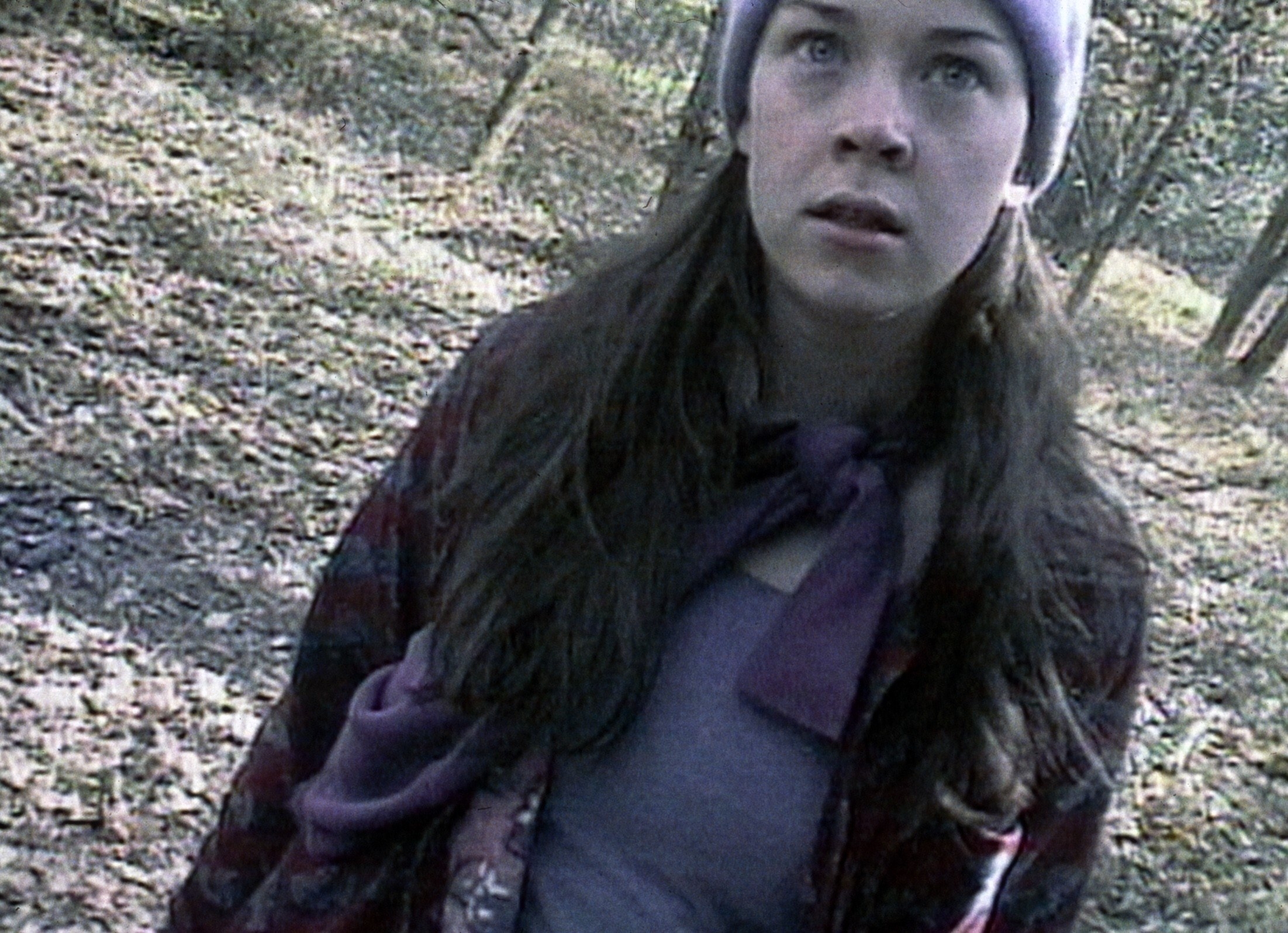 Heather Donahue staring at someone behind the camera in the blair witch project
