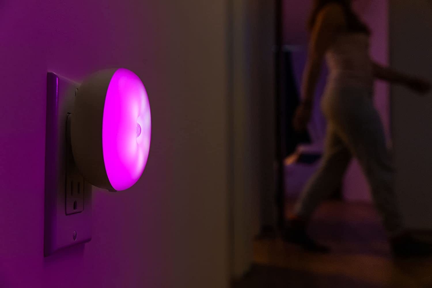 a close up of the colour-changing nightlight plugged into a wall