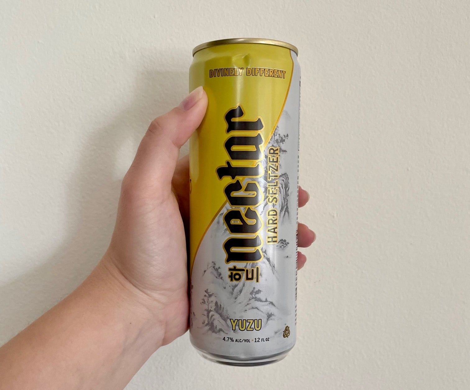 Writer holding a can of the Yuzu flavor