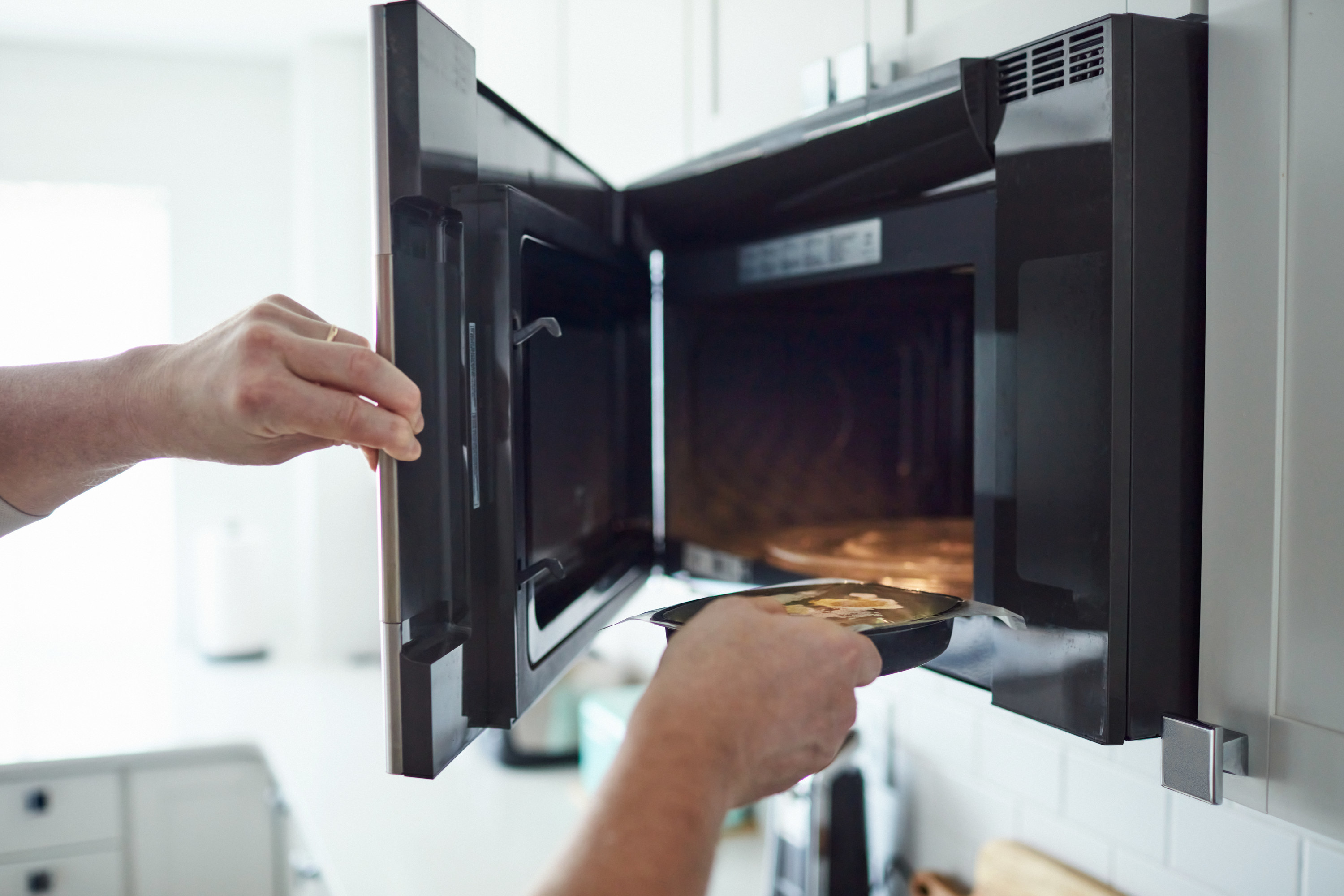 Putting food into a microwave-hood combo
