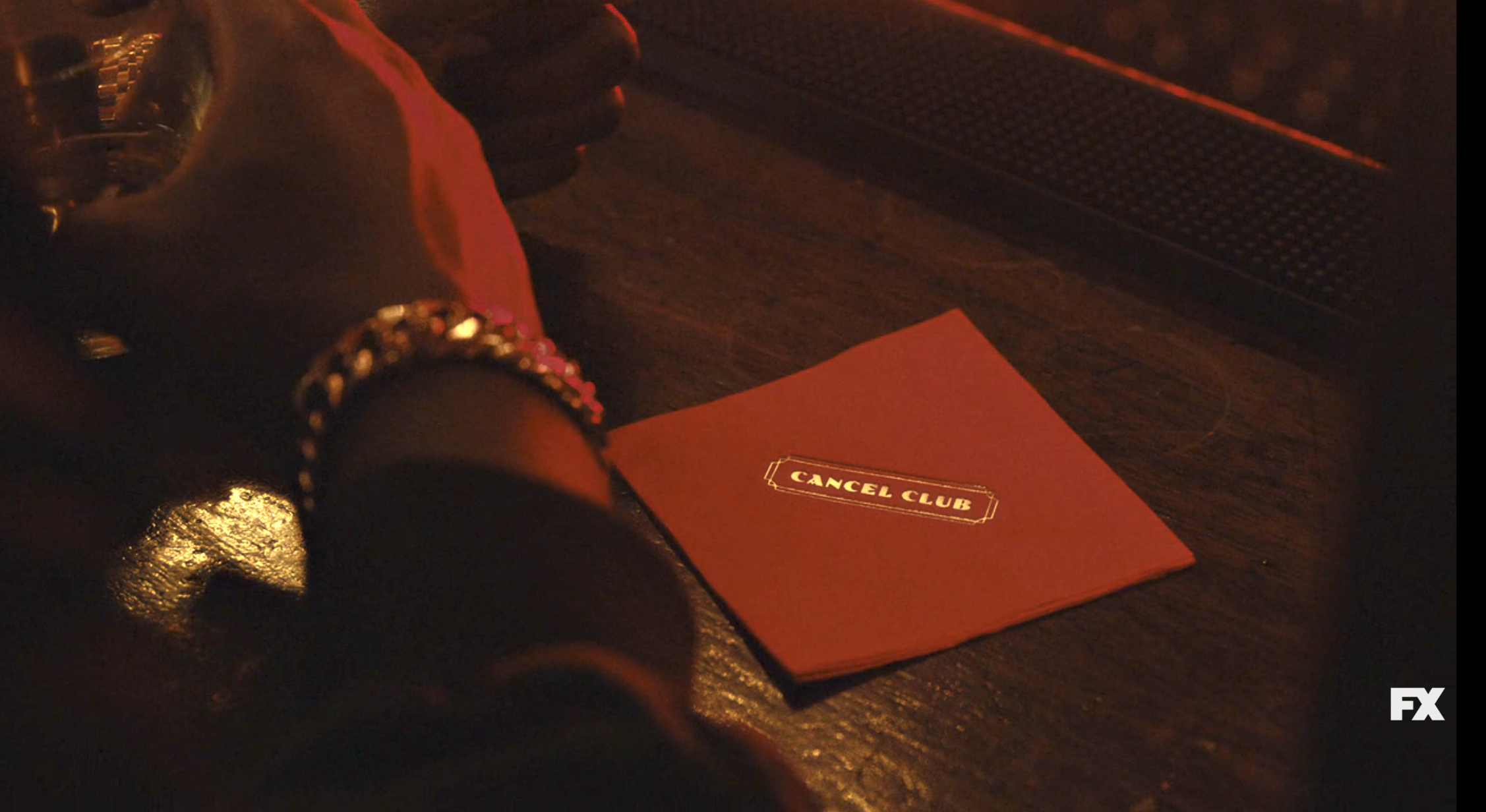 A napkin on the bar with a logo saying Cancel Club