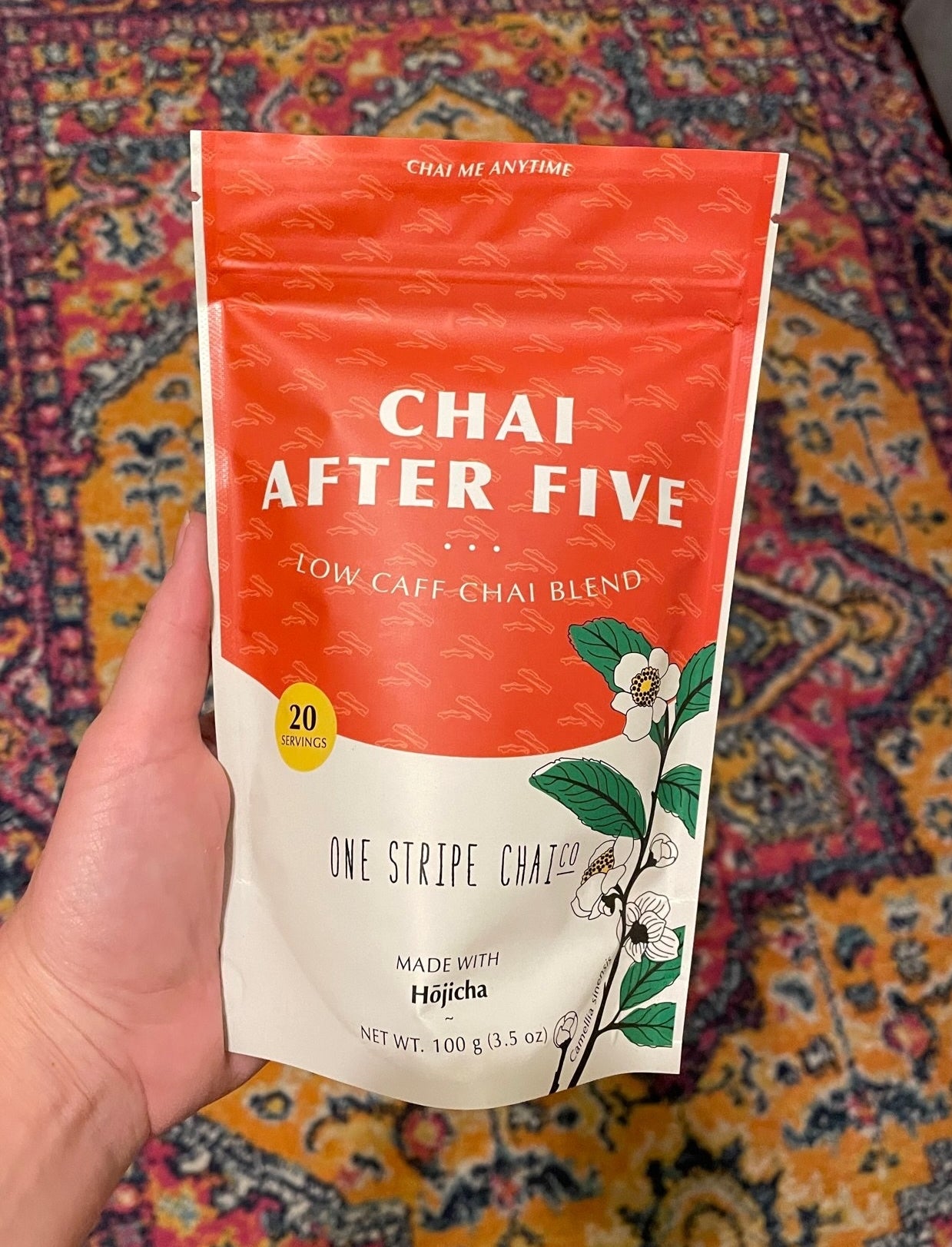 Writer holding a bag of packaged chai tea