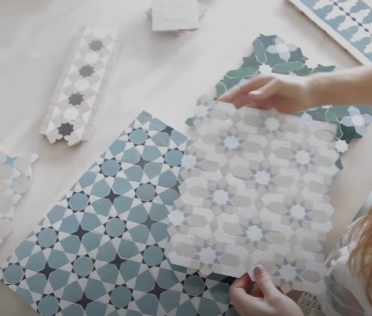 Person sorting through different Moroccan-themed tile