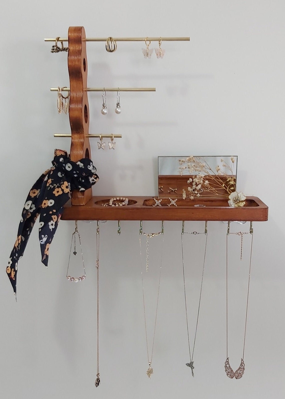 a wall mounted wood jewelry organizer
