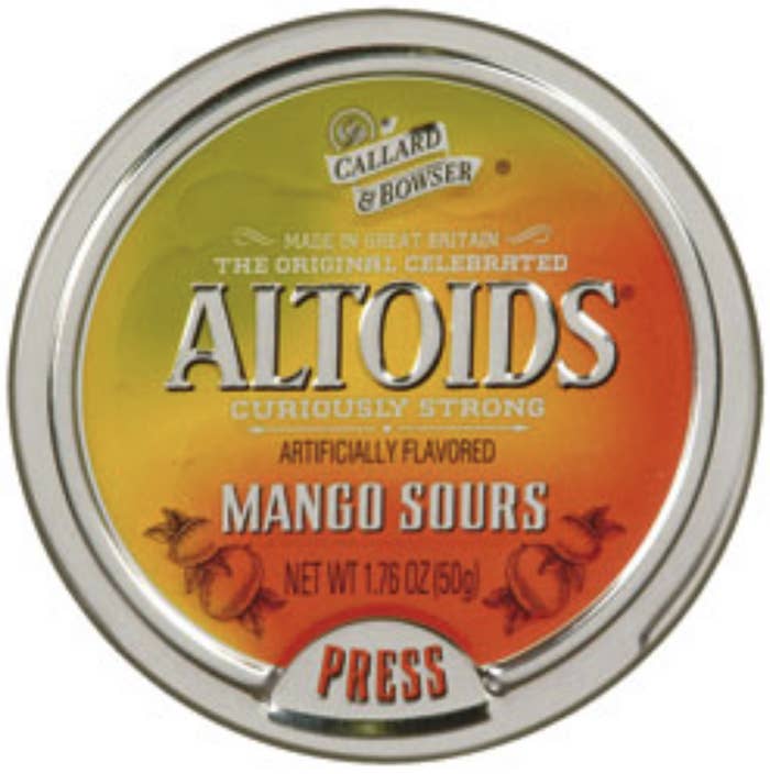 altoids round tin that says "mango sours" on it