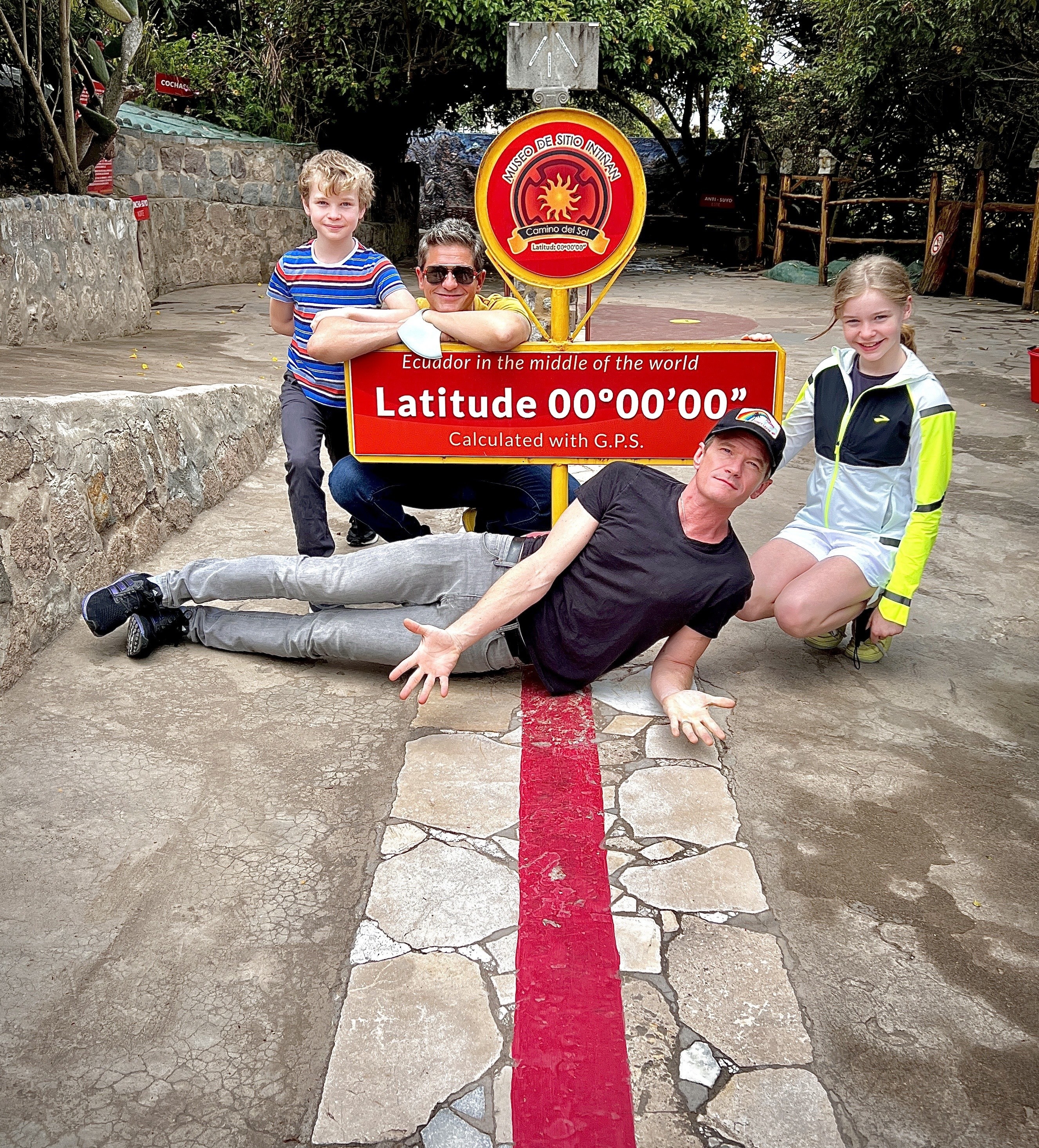 Neil Patrick Harris lying down across a line that marks the Equator