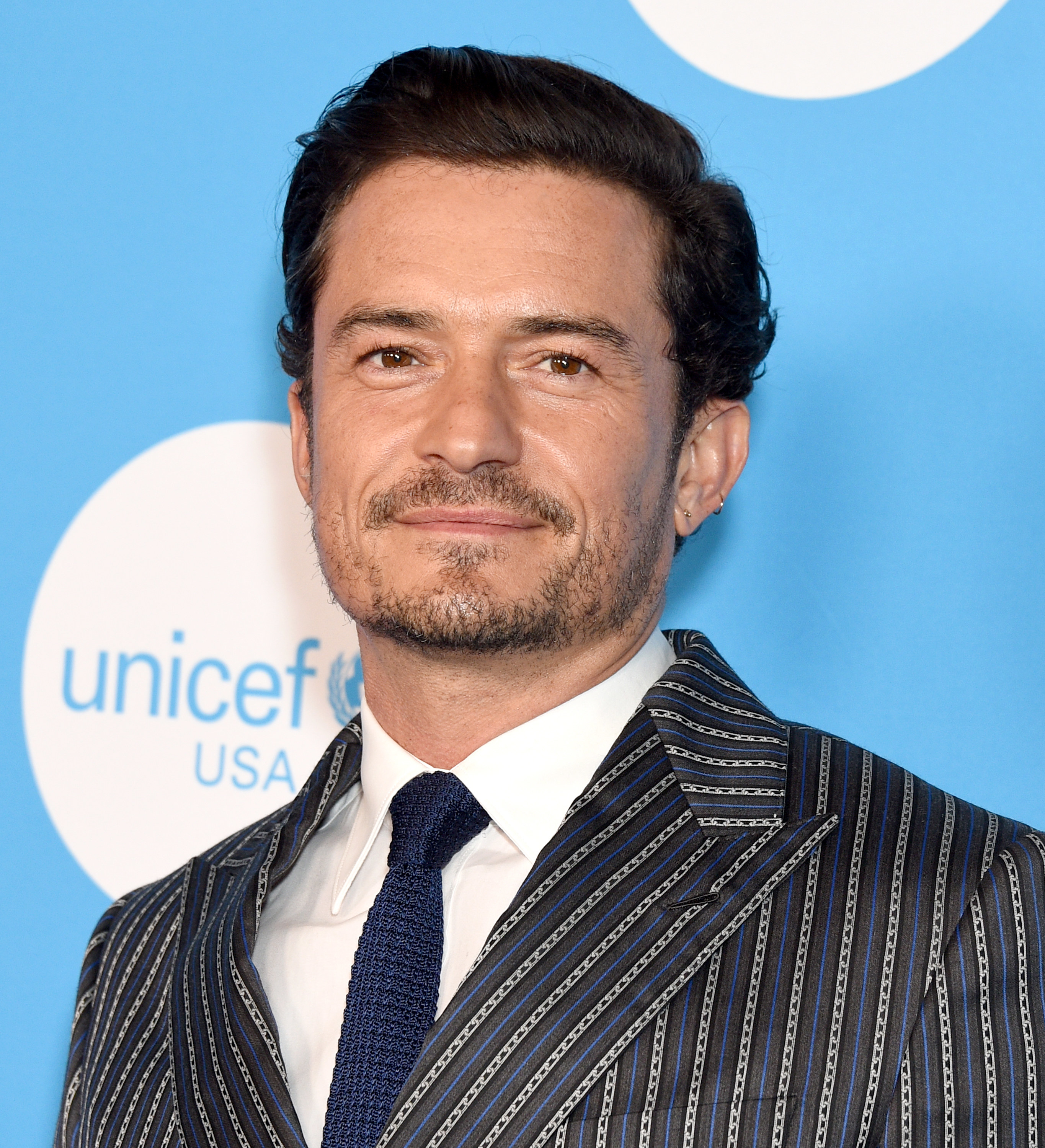 Orlando Bloom poses at the UNICEF At 75 event on November 30, 2021