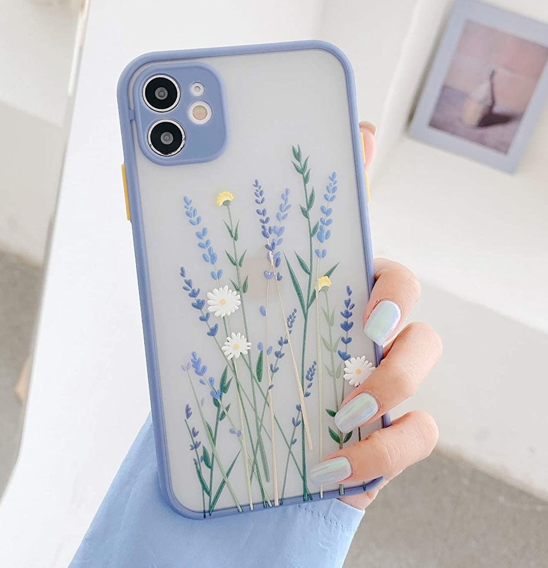 a person holding the floral phone case