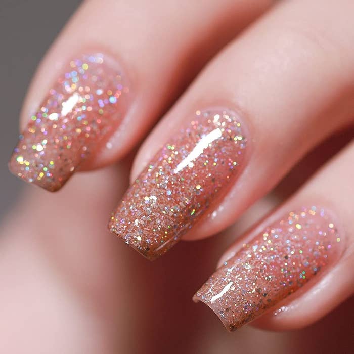 finger nails painted in shimmering sparkles